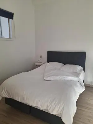 a bedroom with a large bed with white sheets and pillows at Midi Gateway in Brussels