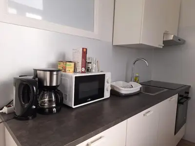a kitchen counter with a microwave and a coffee maker at Midi Gateway in Brussels