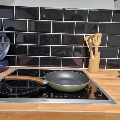 a frying pan on top of a stove in a kitchen at Full apartment near Brussels and Zaventem in Vilvoorde