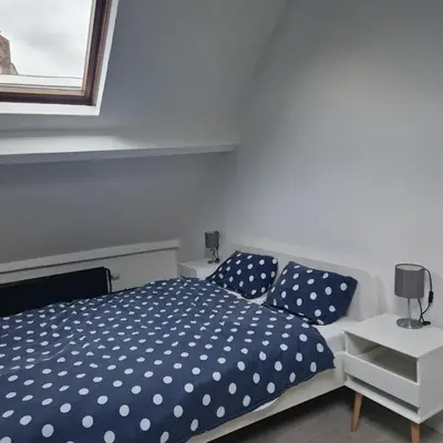 a bedroom with a bed with blue and white polka dots at Full apartment near Brussels and Zaventem in Vilvoorde