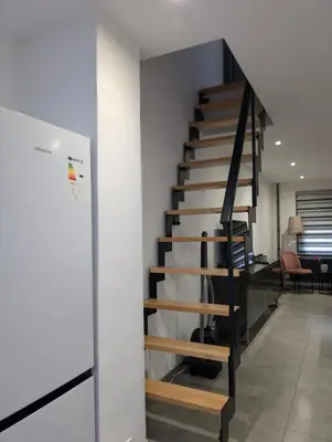 a spiral staircase in a room with a desk at Full apartment near Brussels and Zaventem in Vilvoorde