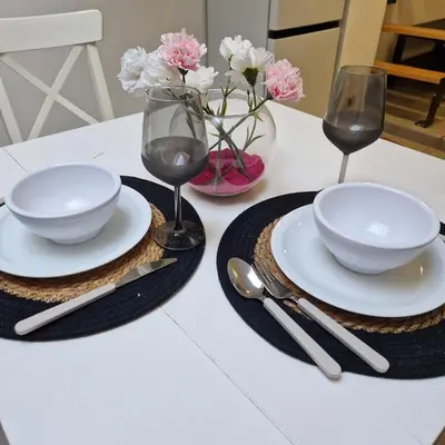 a table with two plates and two glasses of wine at Full apartment near Brussels and Zaventem in Vilvoorde