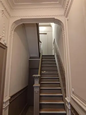 a hallway with a staircase in a building at cosy studio in Antwerp