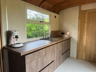 a kitchen with a sink and a window at PipoParel in Ravels