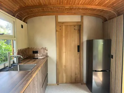 a kitchen with a stainless steel refrigerator next to a counter at PipoParel in Ravels