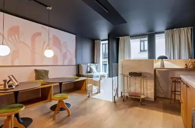a living room with a table and a kitchen at Boutique apartment Antwerp in Antwerp