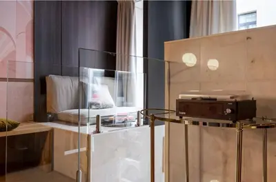 a room with a bed and a glass display case at Boutique apartment Antwerp in Antwerp