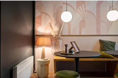 a table with a lamp and a vase on a desk at Boutique apartment Antwerp in Antwerp