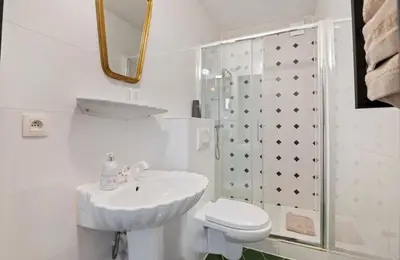 a white bathroom with a sink and a toilet at Boutique apartment Antwerp in Antwerp