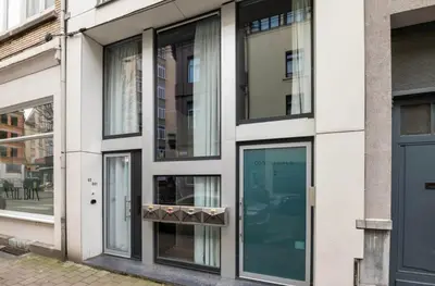 a facade of a building with glass windows at Boutique apartment Antwerp in Antwerp