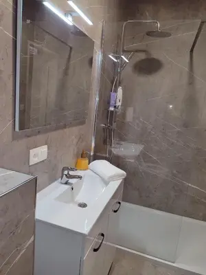 a bathroom with a white sink and a shower at cosy studio2 in Antwerp