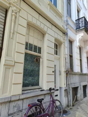 a purple bike parked in front of a building at cosy studio2 in Antwerp