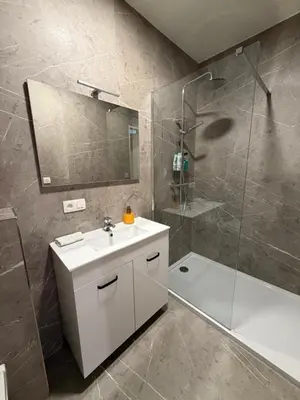 a bathroom with a white sink and a shower at cosy studio2 in Antwerp