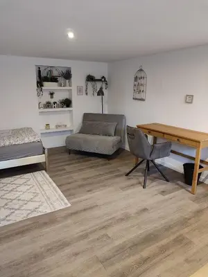 a living room with a desk and a couch at Sweet cozy studio in Antwerp