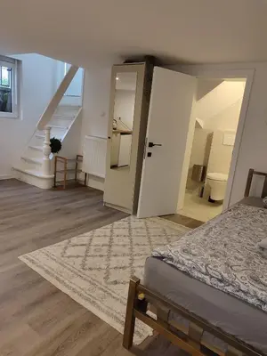 a bedroom with a bed and an open door at Sweet cozy studio in Antwerp