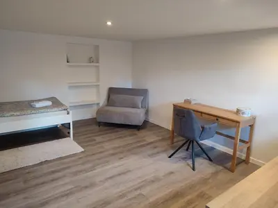 a bedroom with a desk and a chair and a desk at Sweet cozy studio in Antwerp