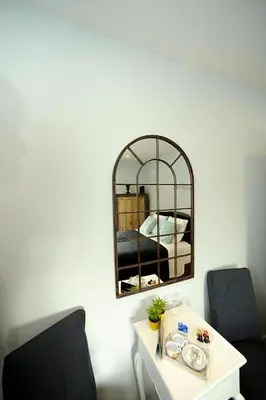 a room with two chairs and a table with a mirror at Guesthouse Expo 13 in Ghent