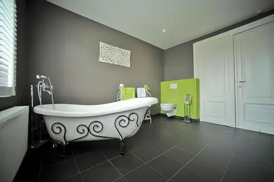 a bathroom with a white tub and a toilet at Guesthouse Expo 13 in Ghent