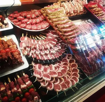 a display case filled with lots of different types of food at Hotel Rietgors in Temse