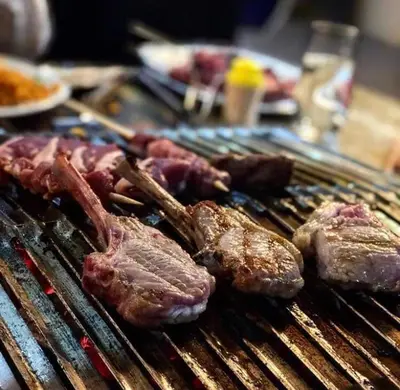 a group of meat on a barbecue grill at Hotel Rietgors in Temse