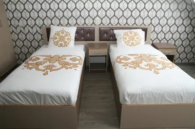 two beds sitting next to each other in a room at Hotel Rietgors in Temse