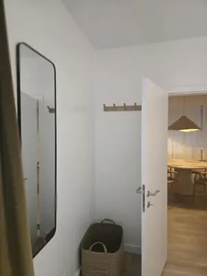 a door to a room with a mirror and a table at Topgelegen Appartement Alma in Antwerp