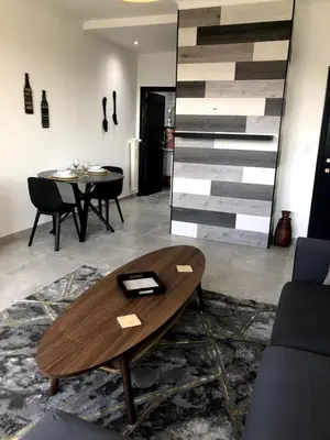 a living room with a wooden coffee table and a couch at Studio 30 Pied a terre in Brussels