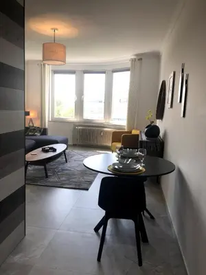 a living room with a table and a couch at Studio 30 Pied a terre in Brussels