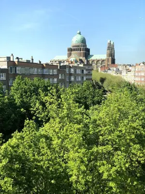 a group of trees with a building in the background at Studio 30 Pied a terre in Brussels