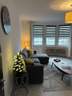 a living room with a couch and a table at Studio 30 Pied a terre in Brussels