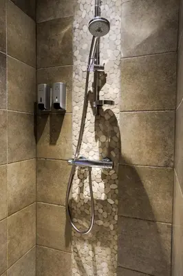 a shower with a shower head in a bathroom at Bed and breakfast Mentari in Ghent