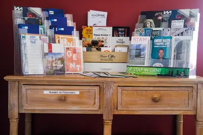 a wooden dresser with books on top of it at Bed and breakfast Mentari in Ghent