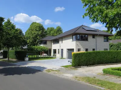 a house with a driveway in front of it at Bed and breakfast Mentari in Ghent