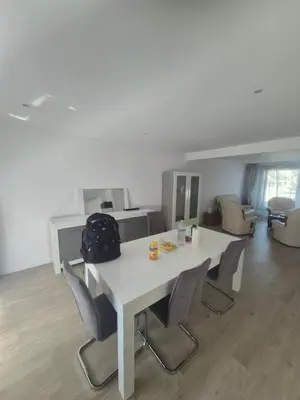 a white table and chairs in a living room at Genius BNB Buyl 2BR Terrace Near City Center Brussels in Brussels