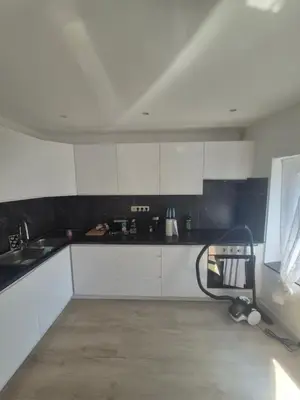 a kitchen with white cabinets and a sink at Genius BNB Buyl 2BR Terrace Near City Center Brussels in Brussels