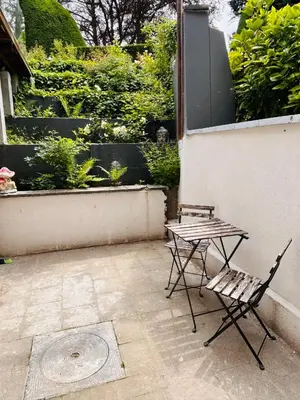 a table and a chair sitting on a patio at Cosy small studio in Brussels