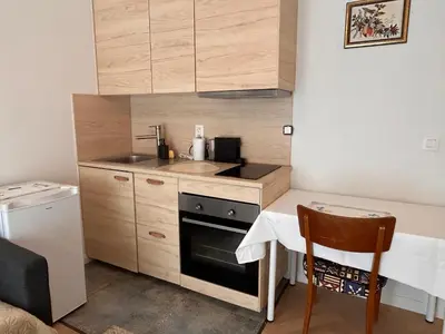 a small kitchen with a sink and a stove at Cosy small studio in Brussels