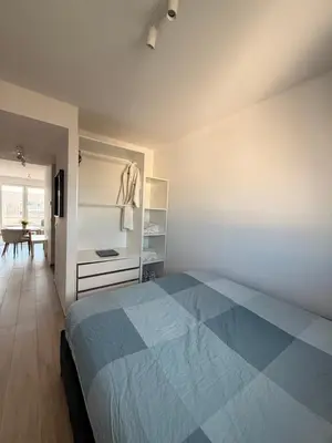 a bedroom with a blue bed and a desk at Séjour lumineux avec Balcon in Brussels