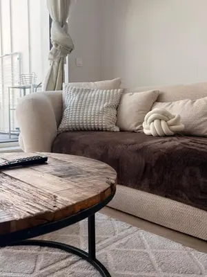 a living room with a couch and a coffee table at Séjour lumineux avec Balcon in Brussels