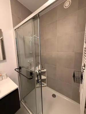 a shower with a glass door in a bathroom at Séjour lumineux avec Balcon in Brussels