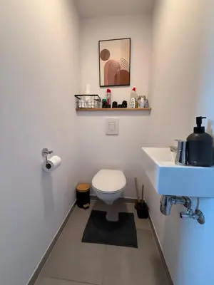 a bathroom with a white toilet and a sink at Séjour lumineux avec Balcon in Brussels