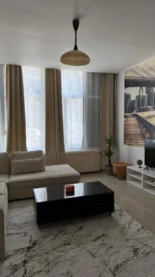 a living room with a couch and a coffee table at Cozy appartement in Brussels- Schuman Area in Brussels