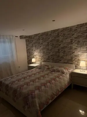 a bedroom with a bed with a brick wall at Cozy appartement in Brussels- Schuman Area in Brussels