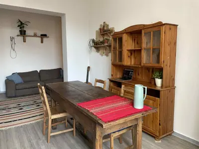 a living room with a wooden table and a couch at Appartement Saint-Gilles in Brussels