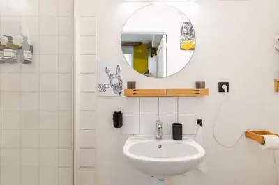 a bathroom with a sink and a mirror at Cosy studio in the heart of Brussels - Grand place in Brussels