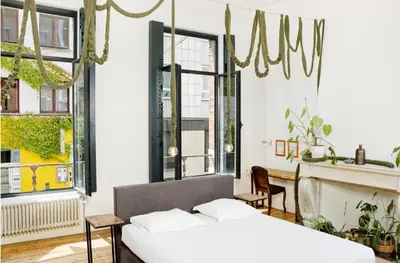 a bedroom with two beds and a fireplace at B&B DRUUM in Brussels