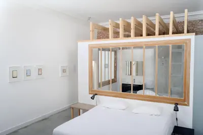 a bedroom with a mirror above a bed at B&B DRUUM in Brussels