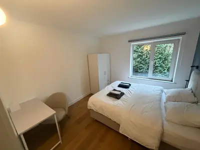 a small bedroom with a bed and a window at businessflat mol center in Mol