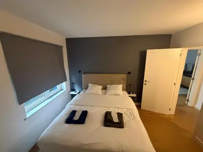 a bedroom with a bed with two towels on it at businessflat mol center in Mol