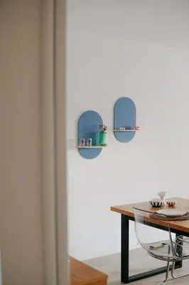 a dining room with a table and two shelves on the wall at Casa Congé - Colorful Stay & Free Wine Bottle in Mechelen
